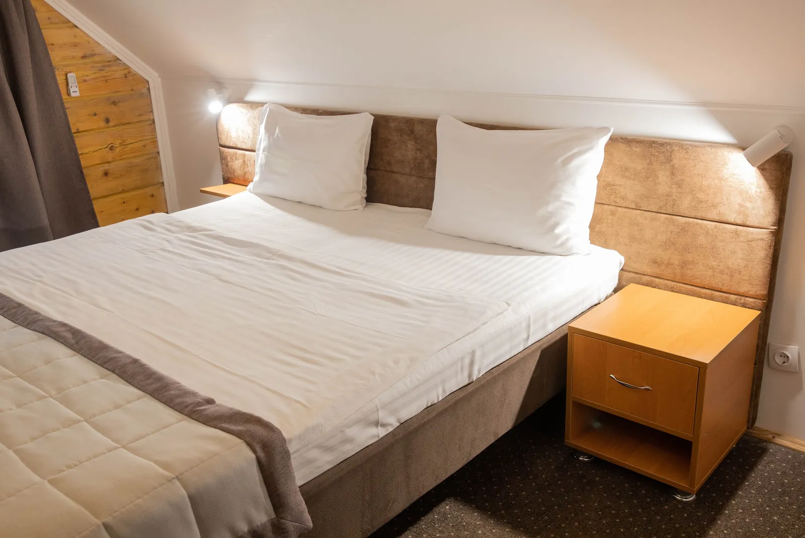 A bedroom with a double bed in a Villa Vita cottage