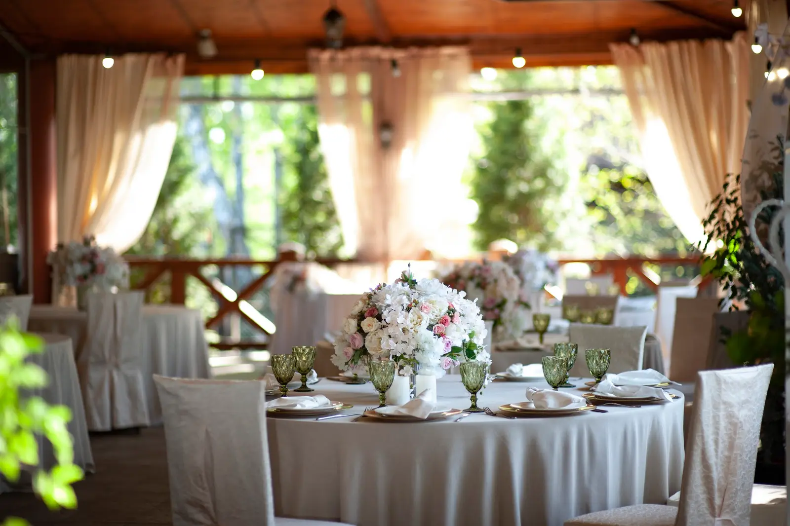Round tables with flowers on the restaurant terrace